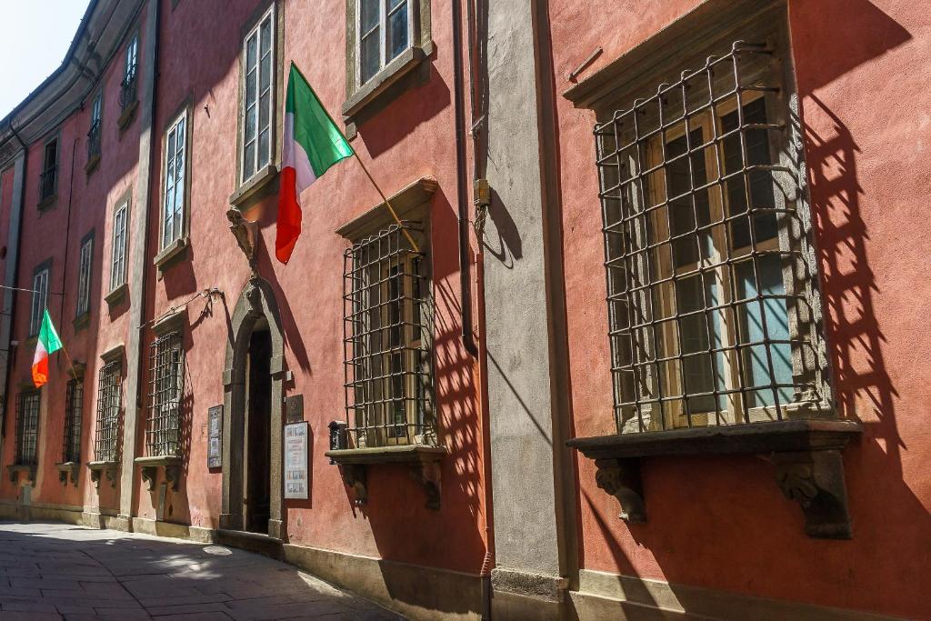 un edificio con dos banderas a un lado en Casa Cordati en Barga