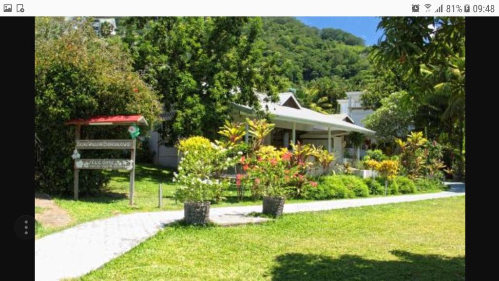 a house with a garden in front of it at Beau Vallon Bungalows in Beau Vallon