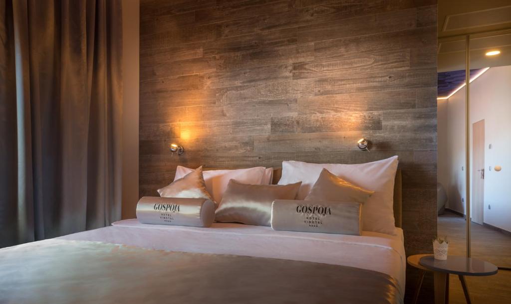 a bedroom with a bed with two pillows on it at Hotel Vinotel Gospoja in Vrbnik