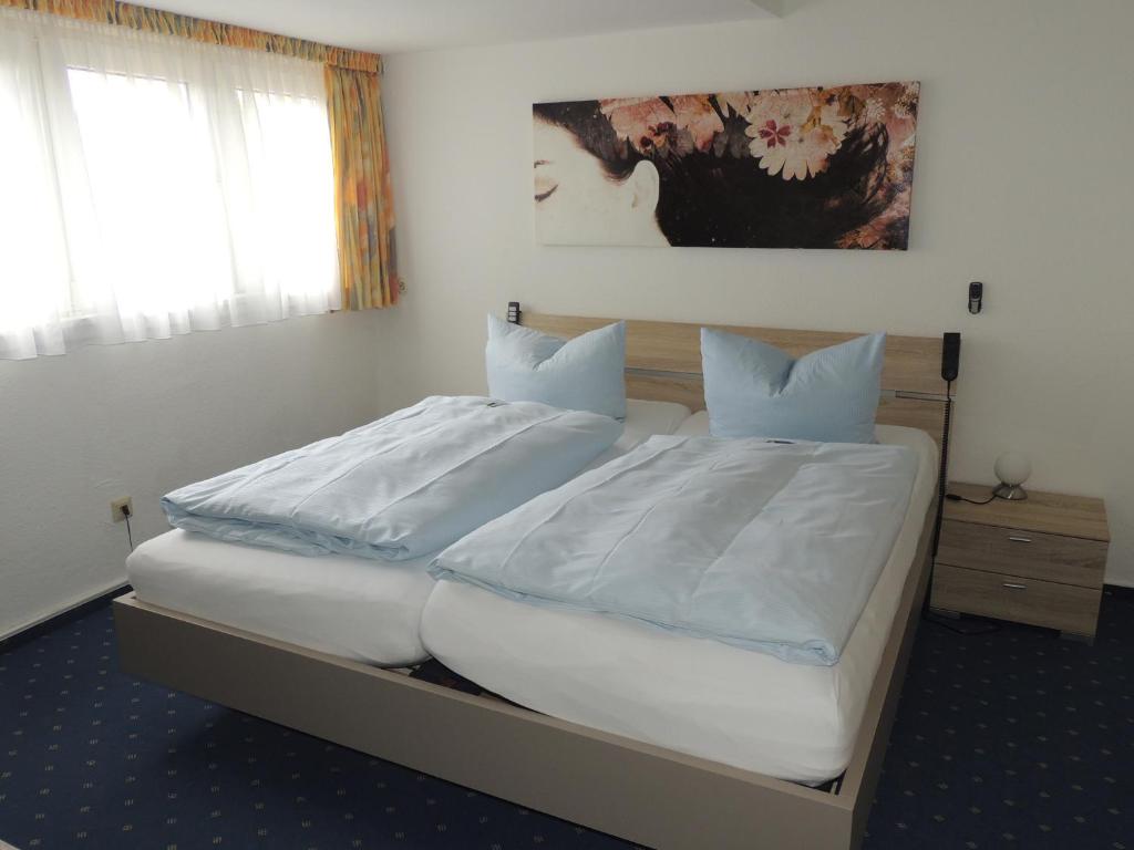 Postel nebo postele na pokoji v ubytování Hotel Stadt Munster