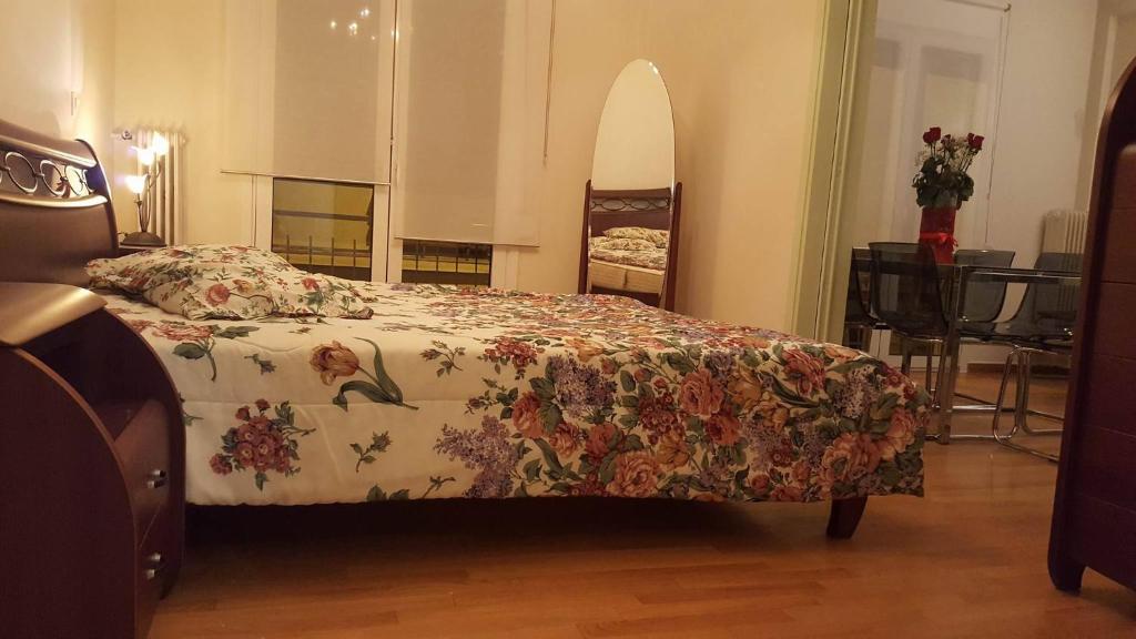 アテネにあるSavvasのベッドルーム1室(花柄のベッドカバー付)