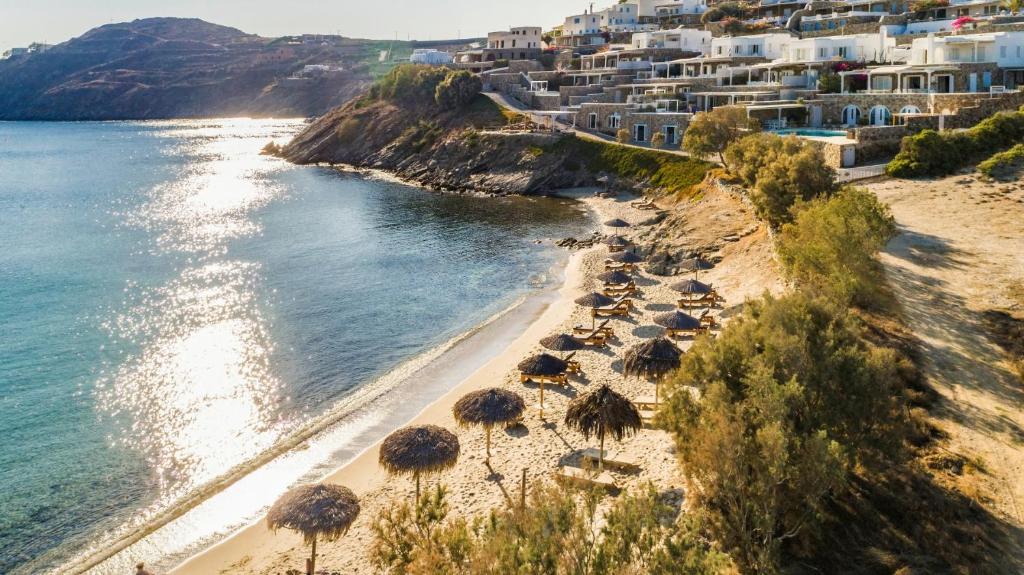 a sandy beach with a large body of water at Casa Del Mar - Small Luxury Hotels of the World in Agios Ioannis Mykonos