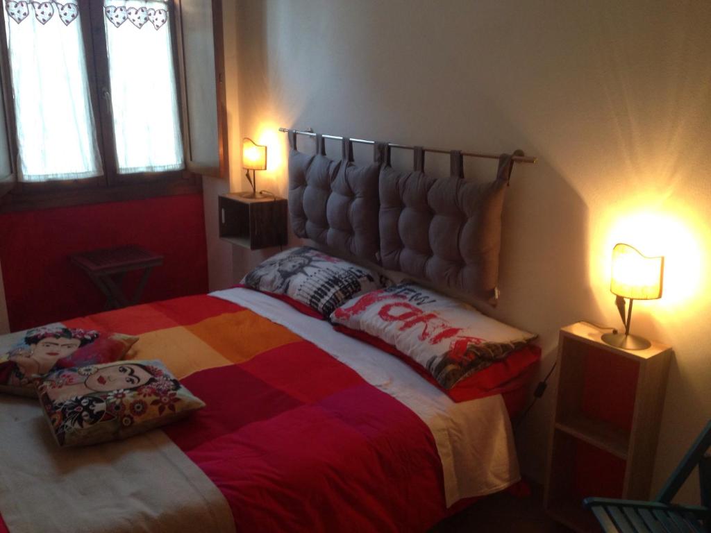 a bedroom with a large bed with two lamps at Casa Mojito o Chupito in Sassari