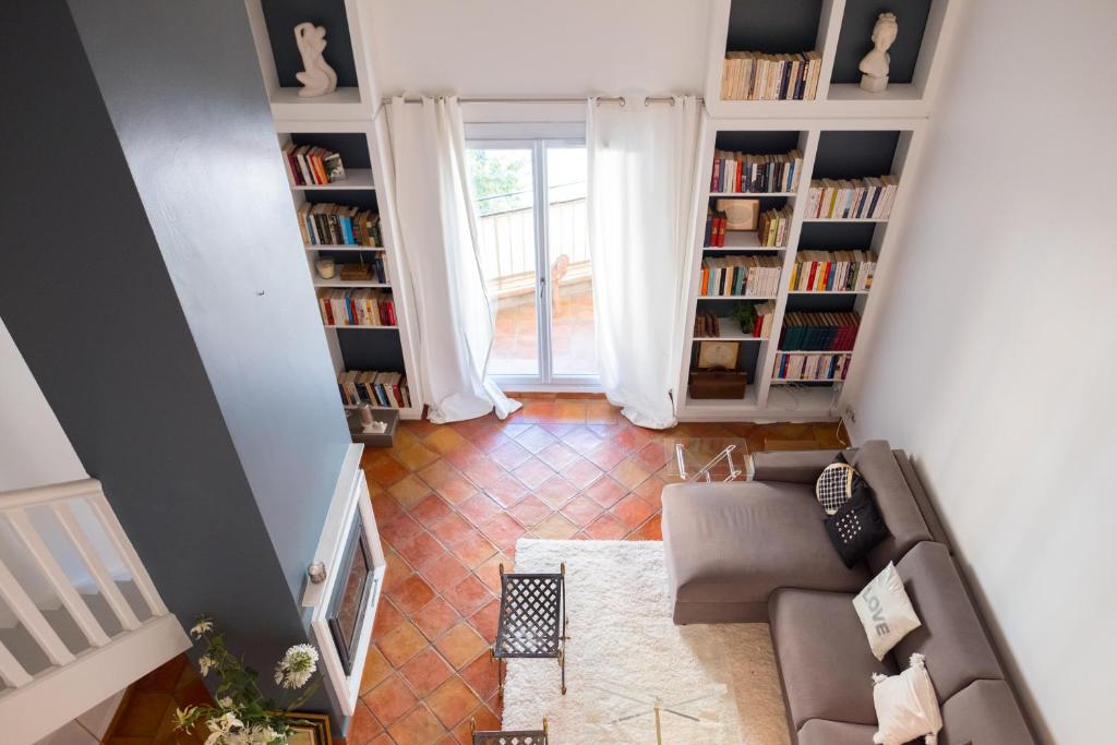 an overhead view of a living room with a couch and book shelves at Perrine Duplex in Saint-Tropez