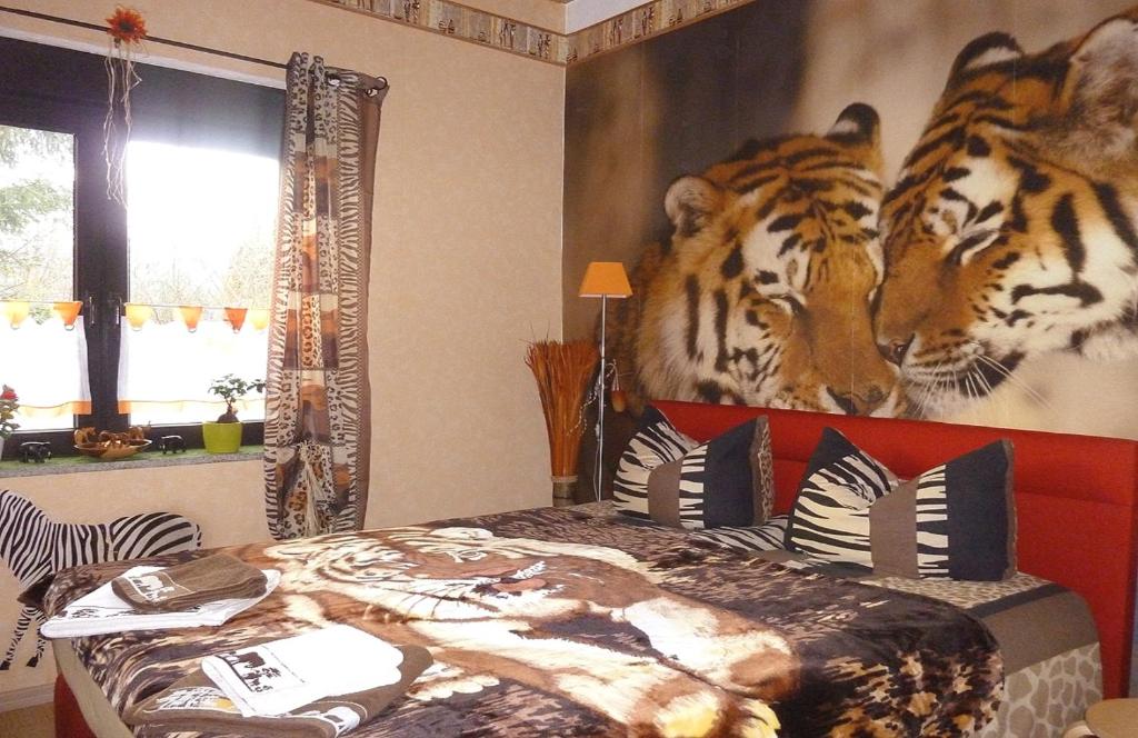 a bedroom with a mural of tigers on the wall at Ferienwohnung direkt in Ilmenau in Ilmenau