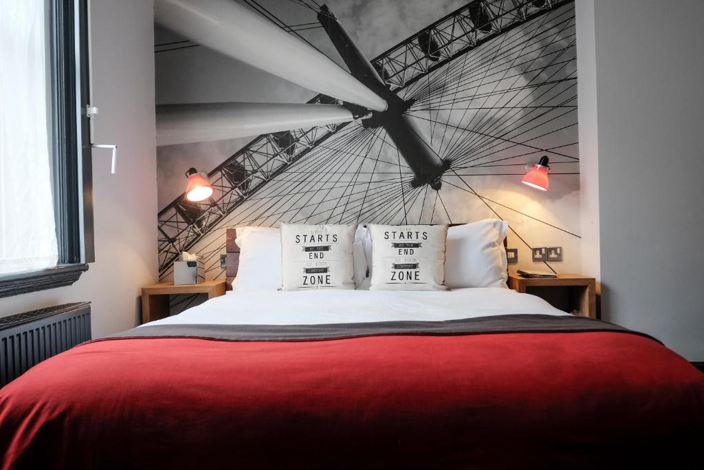 a bed room with a large bed with a canopy over it at The Wellington Hotel in London
