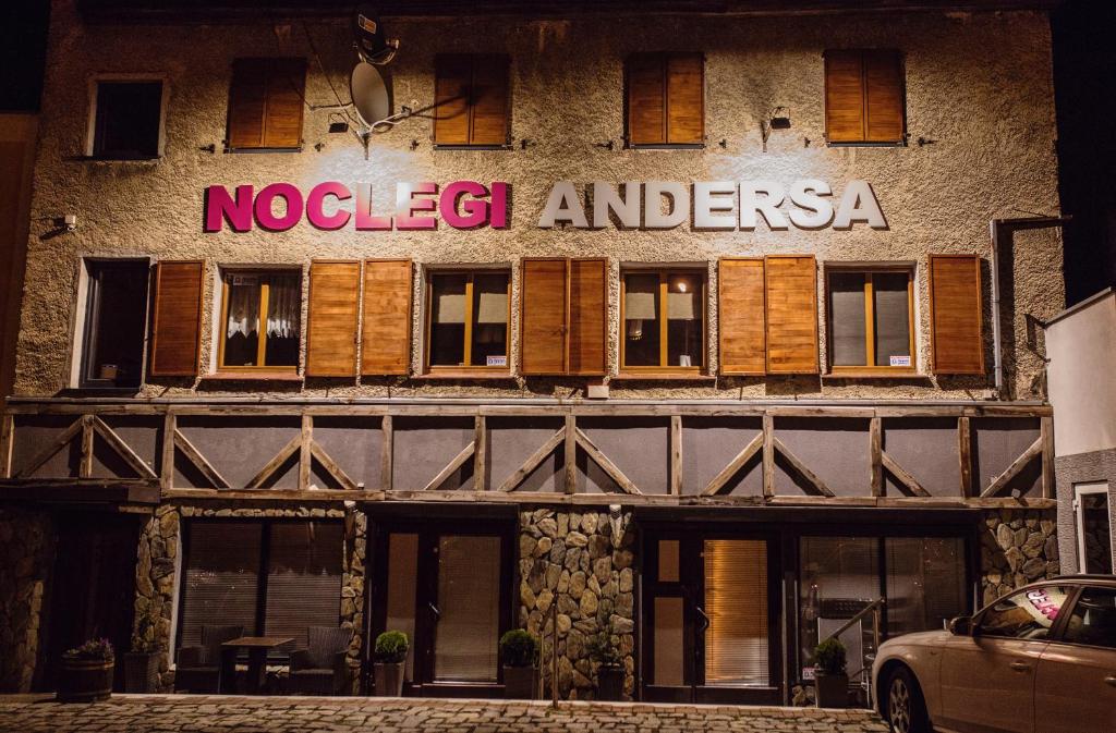 a building with a sign on the side of it at Noclegi Andersa in Wałbrzych
