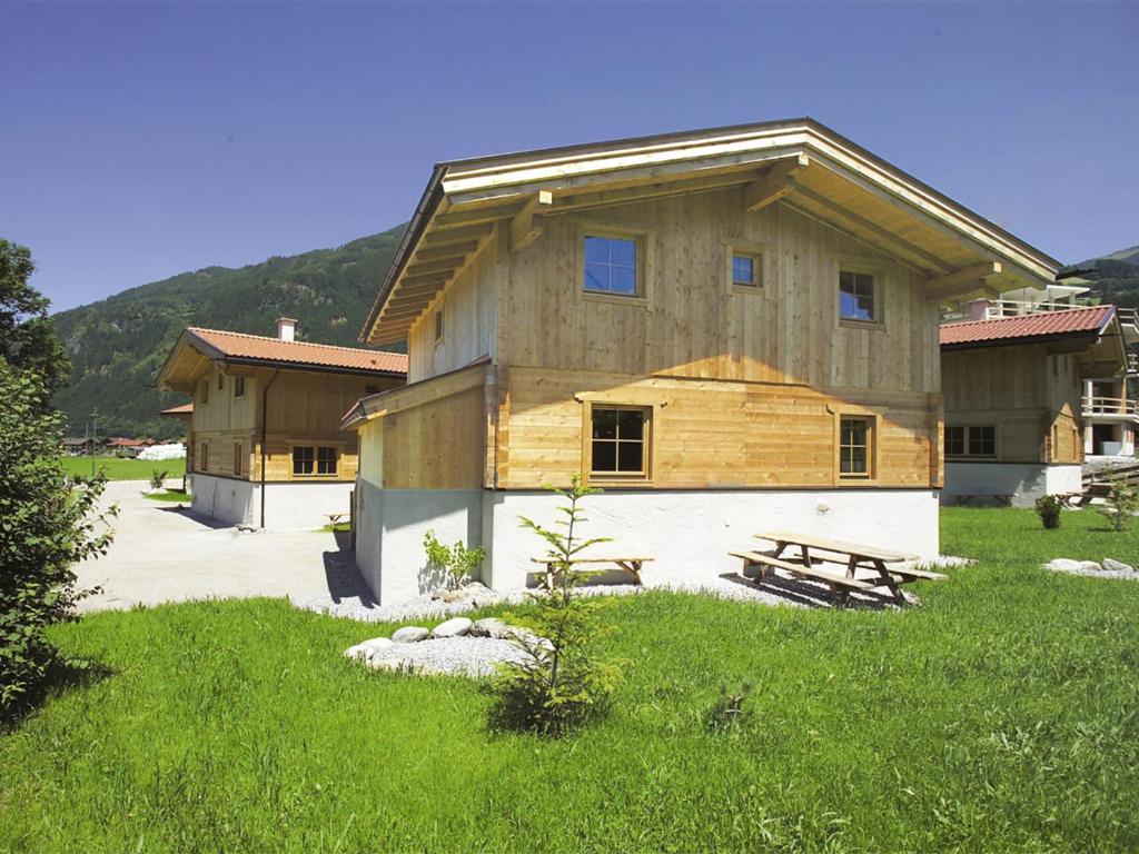 a large wooden house in the middle of a field at Chalet mit Sauna und Kamin A 257.001 in Stumm