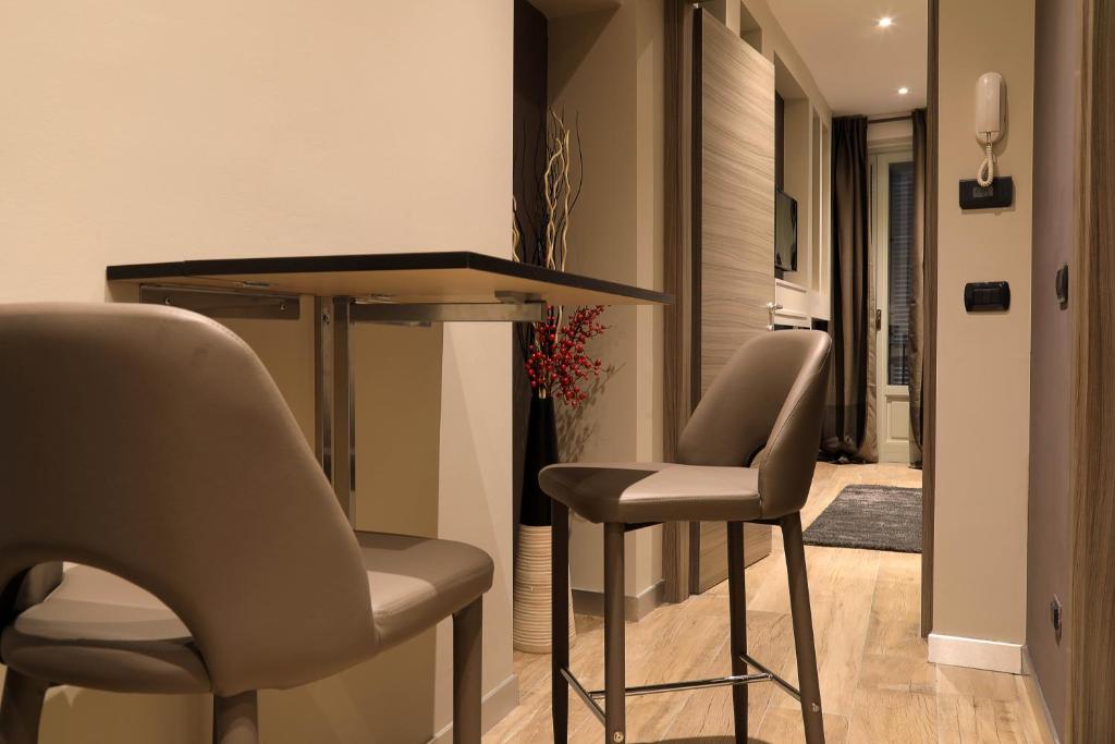 a living room with two chairs and a table at SUITE 11 NEAR DUOMO in Milan