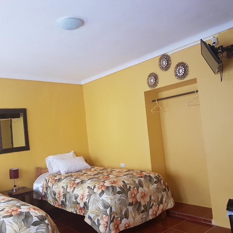 Postel nebo postele na pokoji v ubytování Hospedaje Familiar Kitamayu Pisac