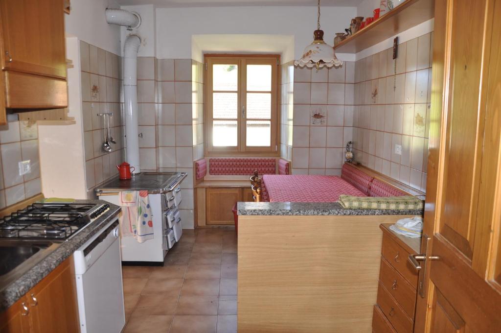 a kitchen with a stove and a counter top at Casa "Berto e Costantina" in Tregiovo
