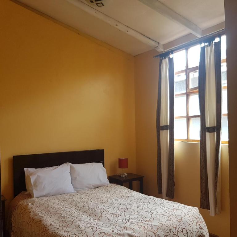 Postel nebo postele na pokoji v ubytování Hospedaje Familiar Kitamayu Pisac