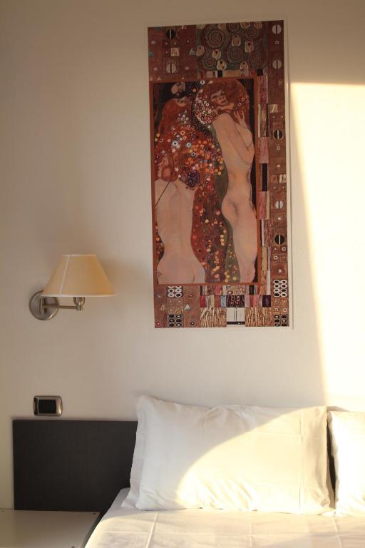 Postel nebo postele na pokoji v ubytování Hotel La Locanda