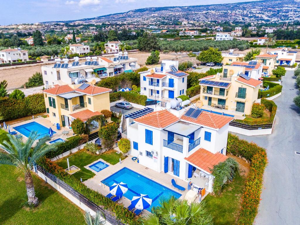an aerial view of a large house with a swimming pool at Kotsias Corallia Villas in Coral Bay
