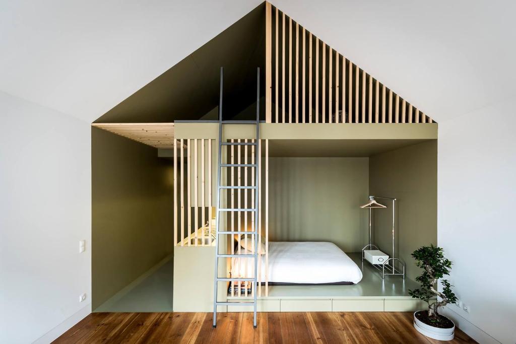 a room with a bunk bed and a staircase at GreenHouse of Porto in Porto