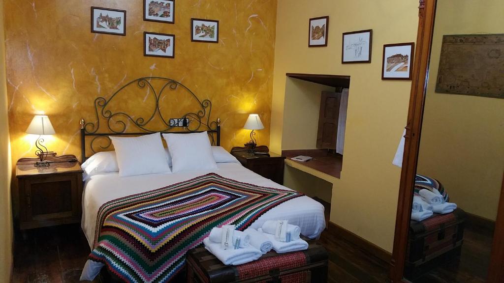 a hotel room with a bed with shoes on it at La Pumarada De Limes 2 in Cangas del Narcea