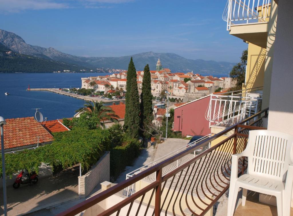 a balcony with a view of a town and water at Apartments Adriatic in Korčula