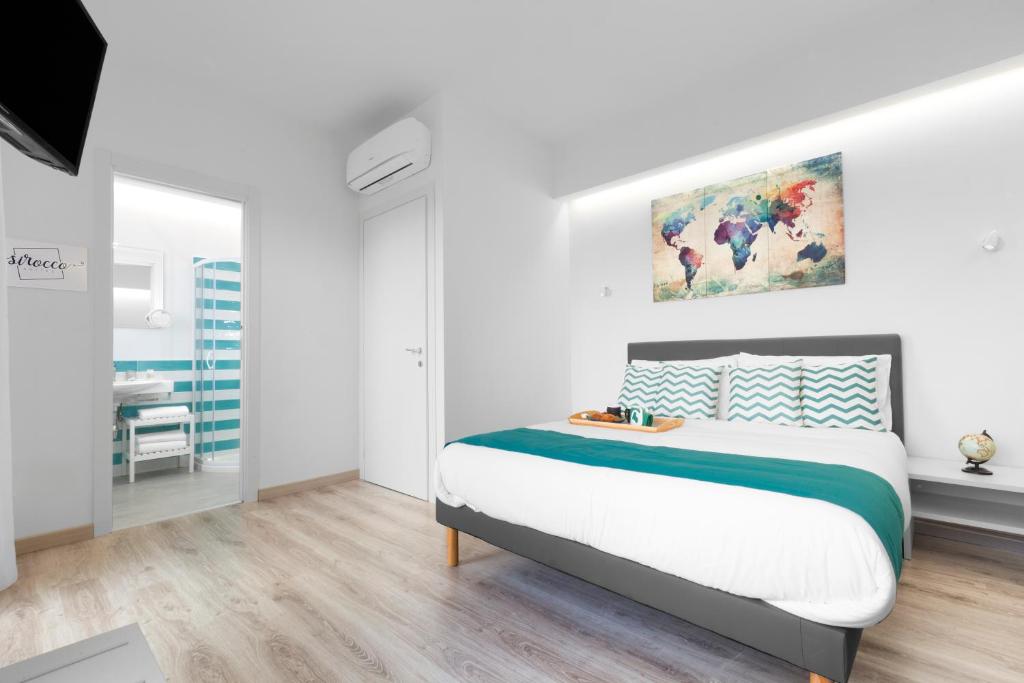 Postel nebo postele na pokoji v ubytování Sirocco Suites