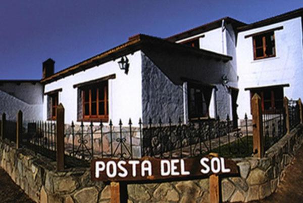 a white house with a sign in front of it at Posta del Sol in Maimará