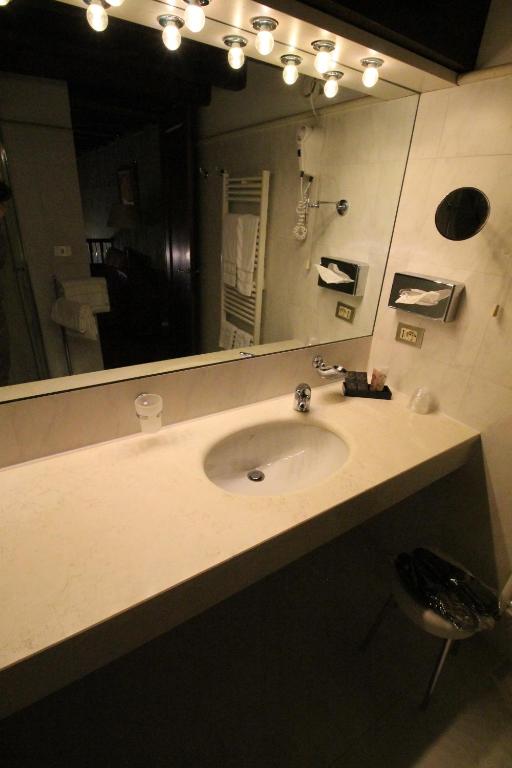 a bathroom with a sink and a large mirror at Hotel Palazzo Abadessa in Venice