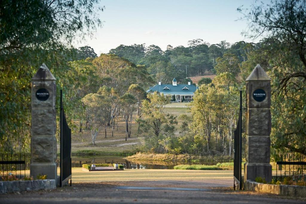 a pair of gates leading to a house at Wandin Valley Estate in Lovedale