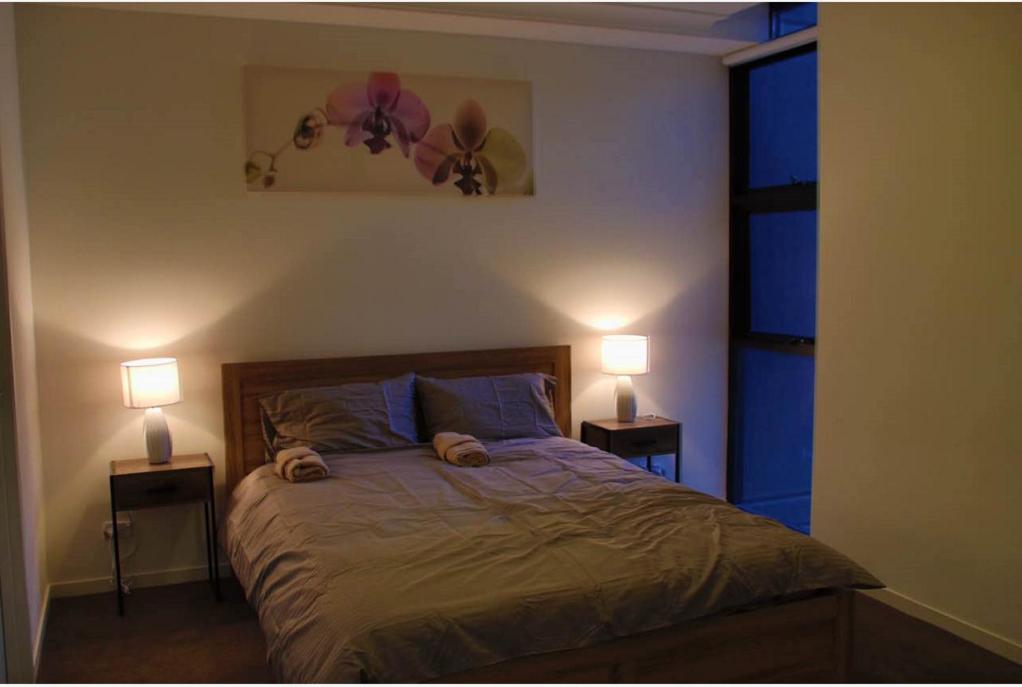 a bedroom with a bed with two lamps on it at Liverpool New Apt 2BR and 2Bath in Liverpool