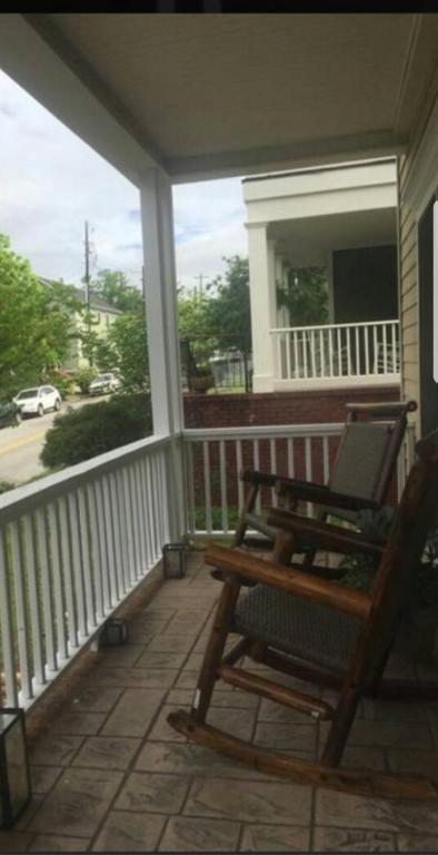 a porch with a rocking chair on a house at Sweet Magnolia in Chattanooga