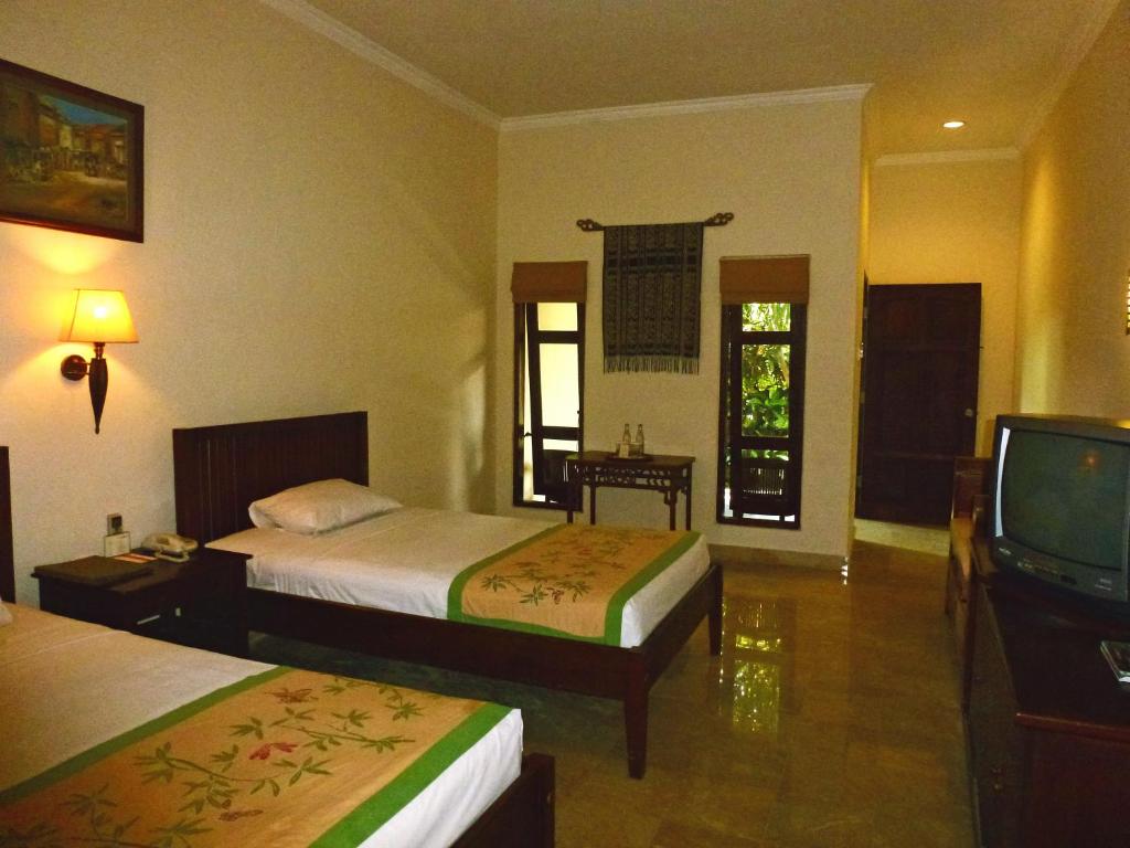 Postel nebo postele na pokoji v ubytování Hotel Puri Bambu