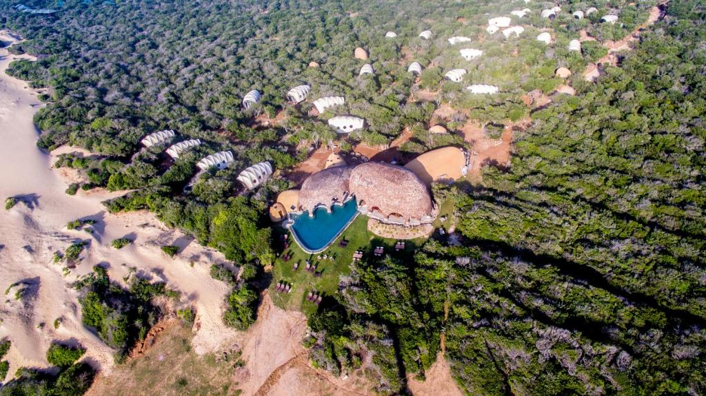 a large airplane flying over a large body of water at Wild Coast Tented Lodge All Inclusive in Yala