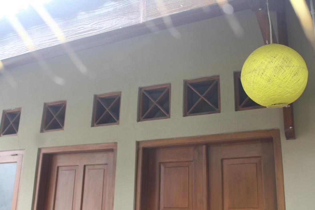 a yellow orb hanging over a door in a building at Rumah Pathuk Syariah Homestay in Yogyakarta