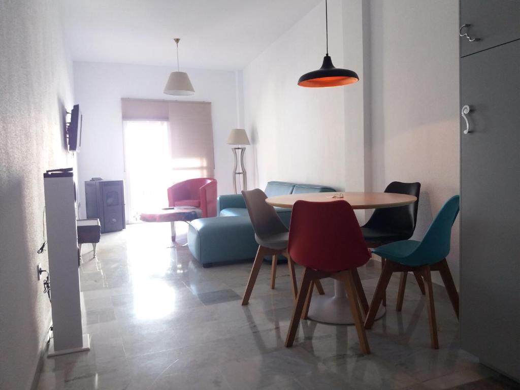 a living room with a table and chairs at Pop Art House Center 2 Bedrooms in Málaga