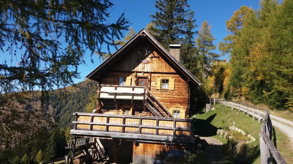 a log cabin in the middle of a forest at Platzerhütte in Unterkolbnitz