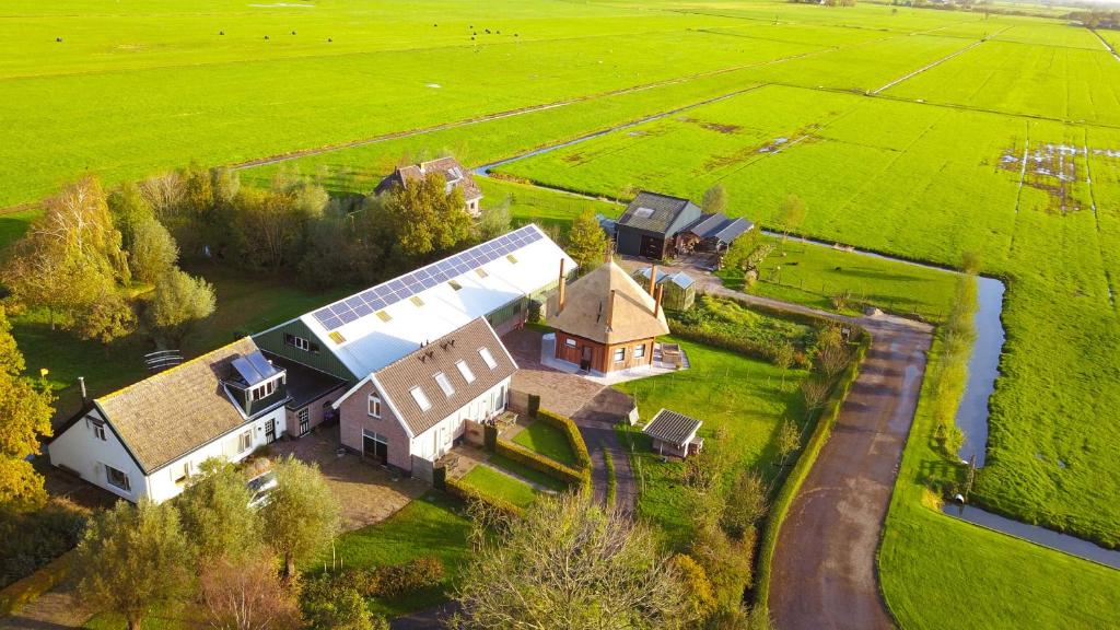 an aerial view of a large barn in a field at Aan de Kwakel in Maasland