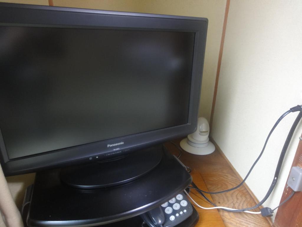 TV a/nebo společenská místnost v ubytování Kasuga Ryokan