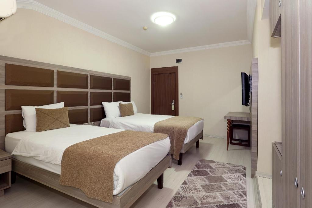 Postel nebo postele na pokoji v ubytování Seckin Hotel