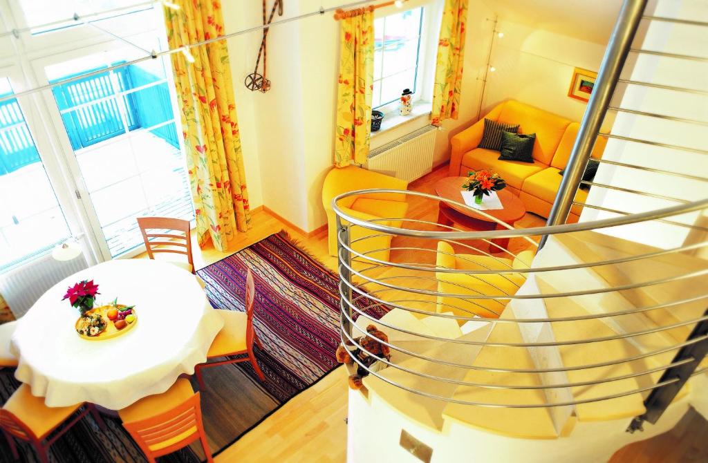 a spiral staircase in a living room with a table at Ferienwohnung Anderl in Obertauern