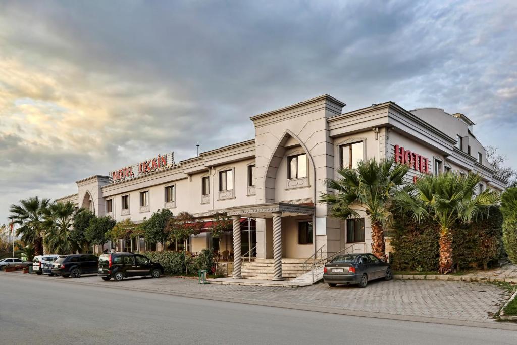 a building on a street with cars parked in front of it at Seckin Hotel in Sakarya