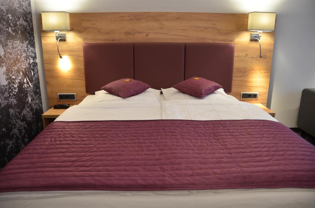 Postel nebo postele na pokoji v ubytování Hotel Touric