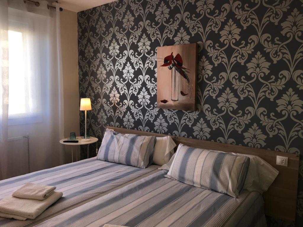 Postel nebo postele na pokoji v ubytování Alojamientos Olga