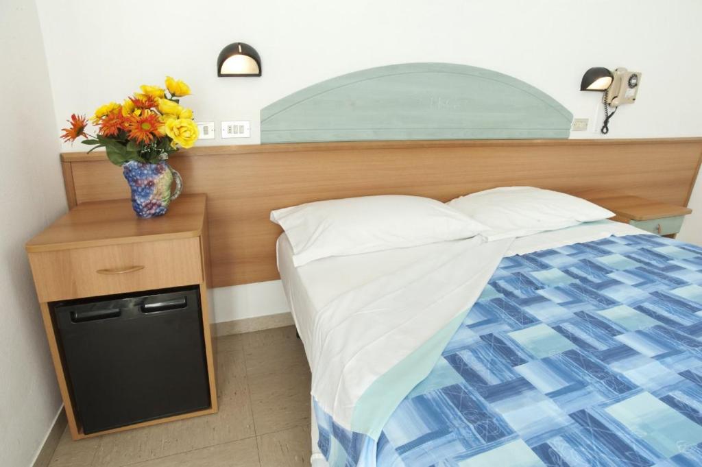 Postel nebo postele na pokoji v ubytování Hotel Giunchi
