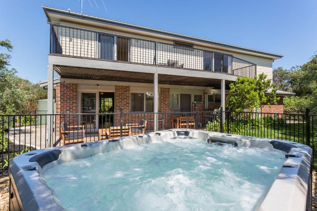 a hot tub in front of a house at Ocean Breeze Retreat - with spa and space in Saint Andrews Beach