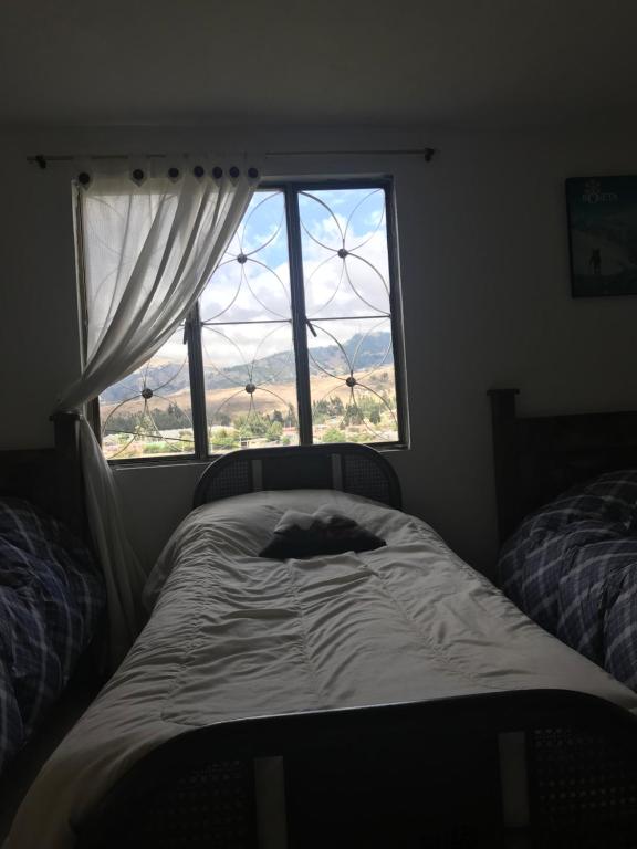 Postel nebo postele na pokoji v ubytování Hostal Casa Lantana