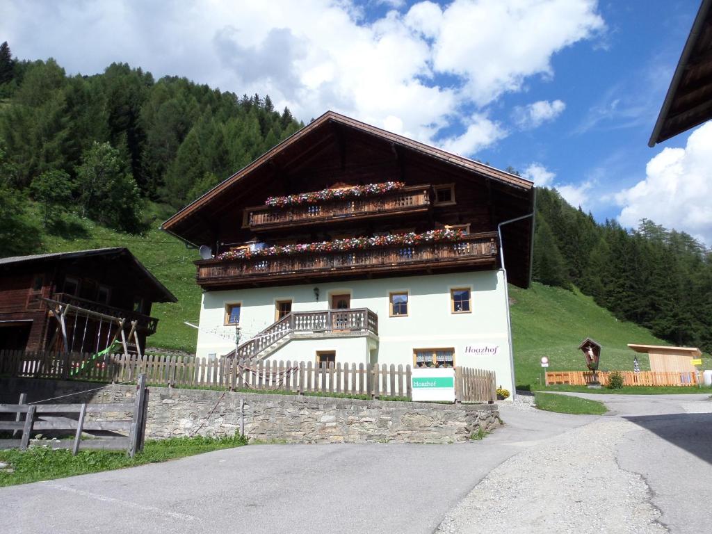 a building with people sitting on the balconies of it at Hoazhof in Kals am Großglockner