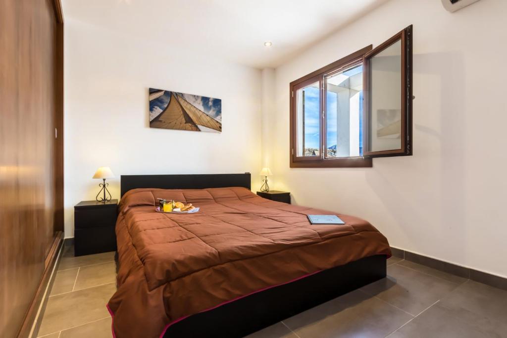 A bed or beds in a room at Townhouse Calvari By homevillas360