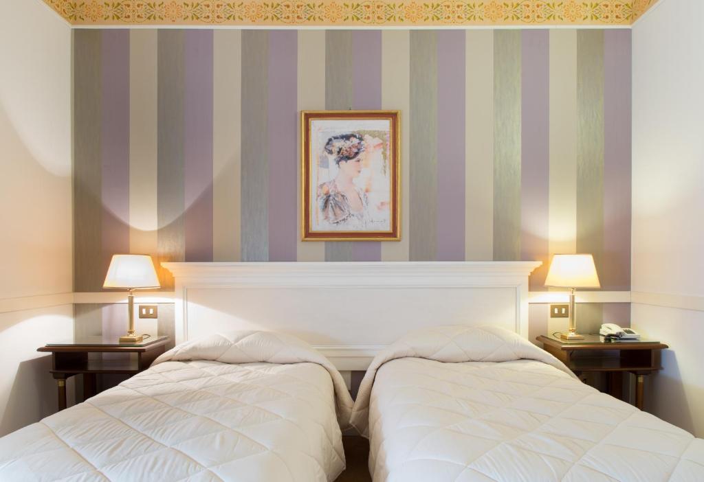 Postel nebo postele na pokoji v ubytování Hotel Tuder