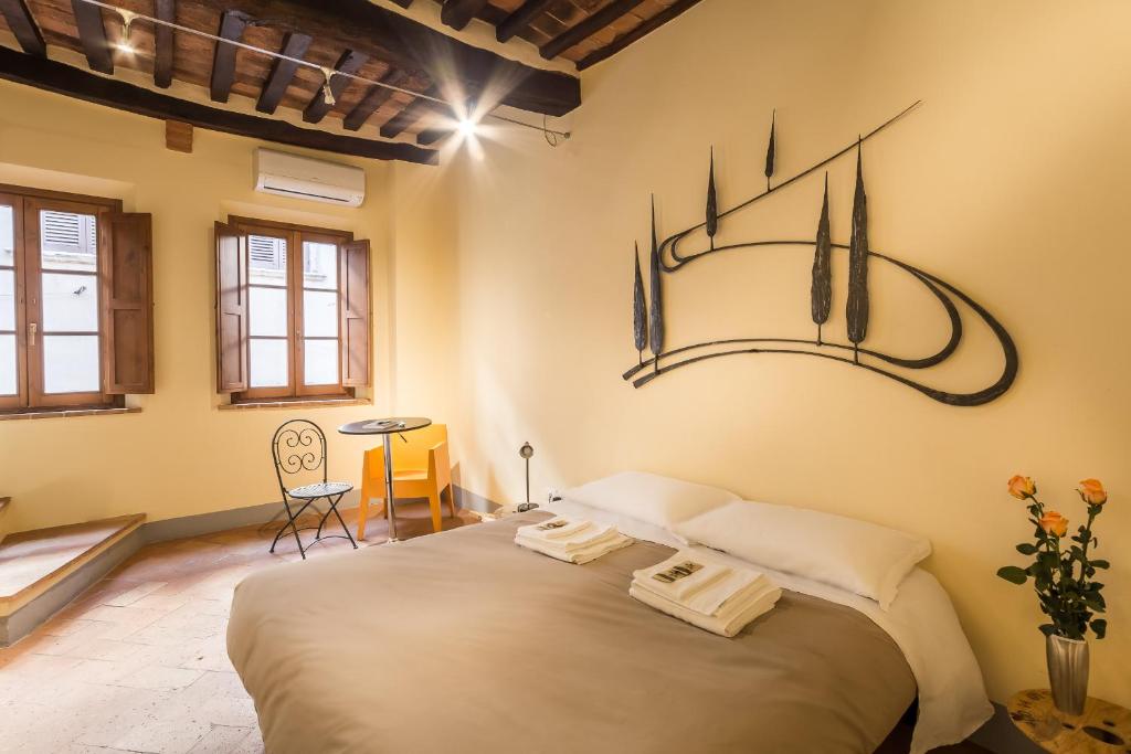 a bedroom with a large bed in a room at Guesthouse Via Di Gracciano - Adults Only in Montepulciano