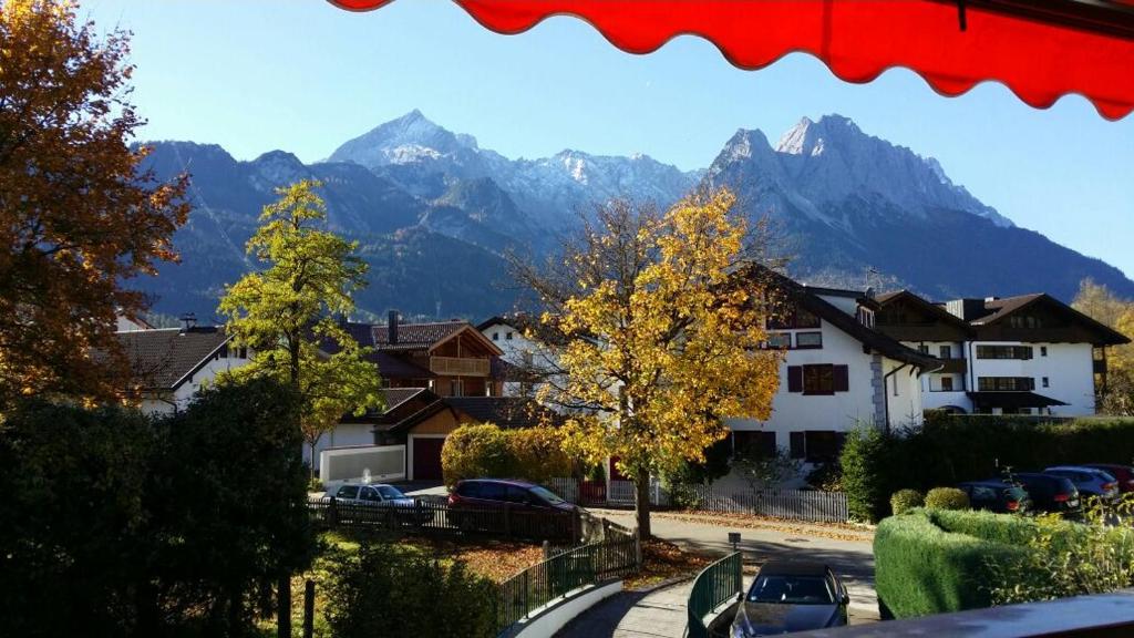 a view of a mountain range with cars parked at Fewo Königsberger in Garmisch-Partenkirchen