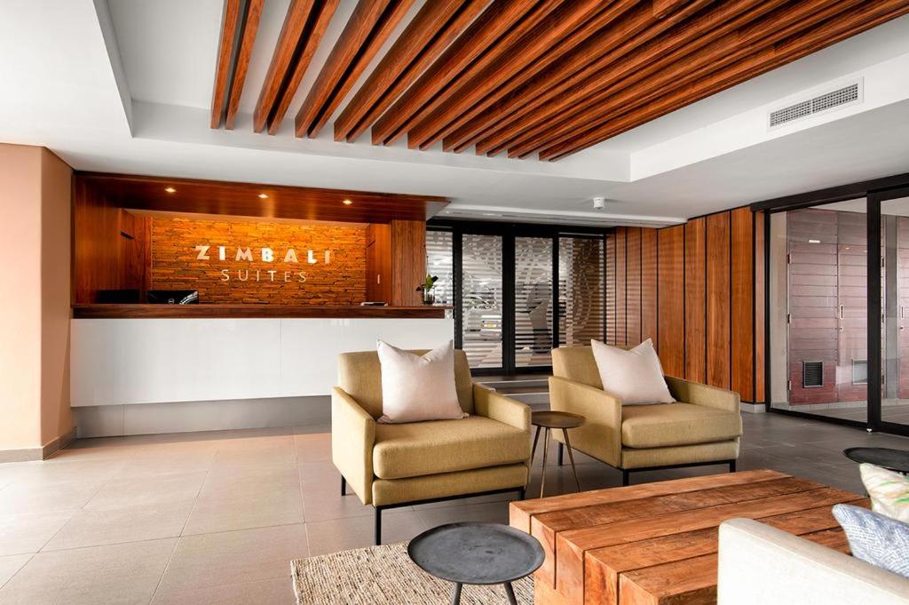 a living room with two chairs and a table at Zimbali Suite 419 in Ballito