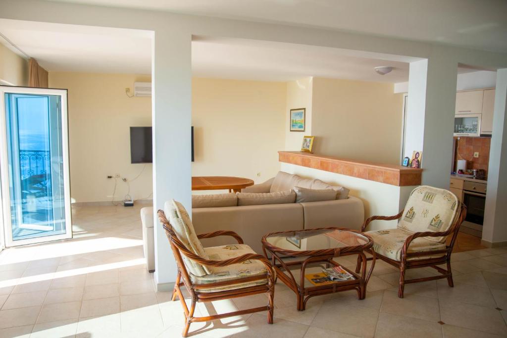 a living room with a couch and chairs at Villa Edelweiss in Sveti Stefan
