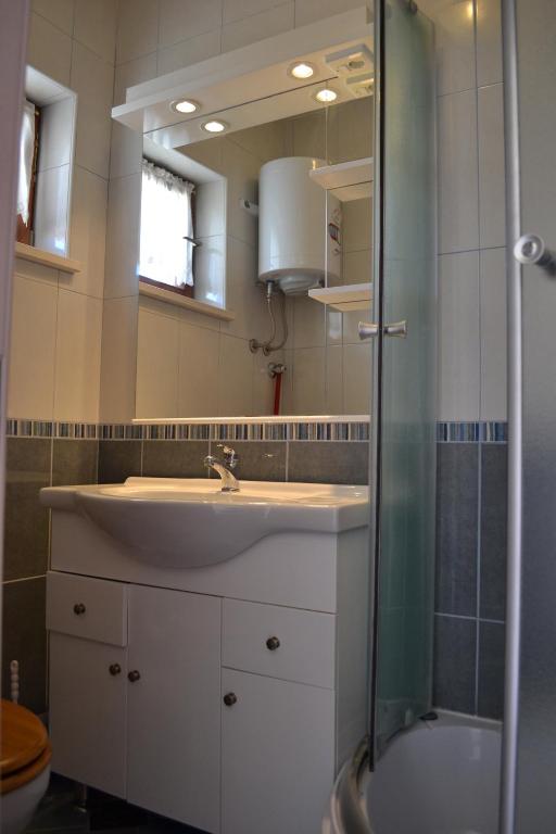a bathroom with a sink and a shower at Villa Agava in Vrboska